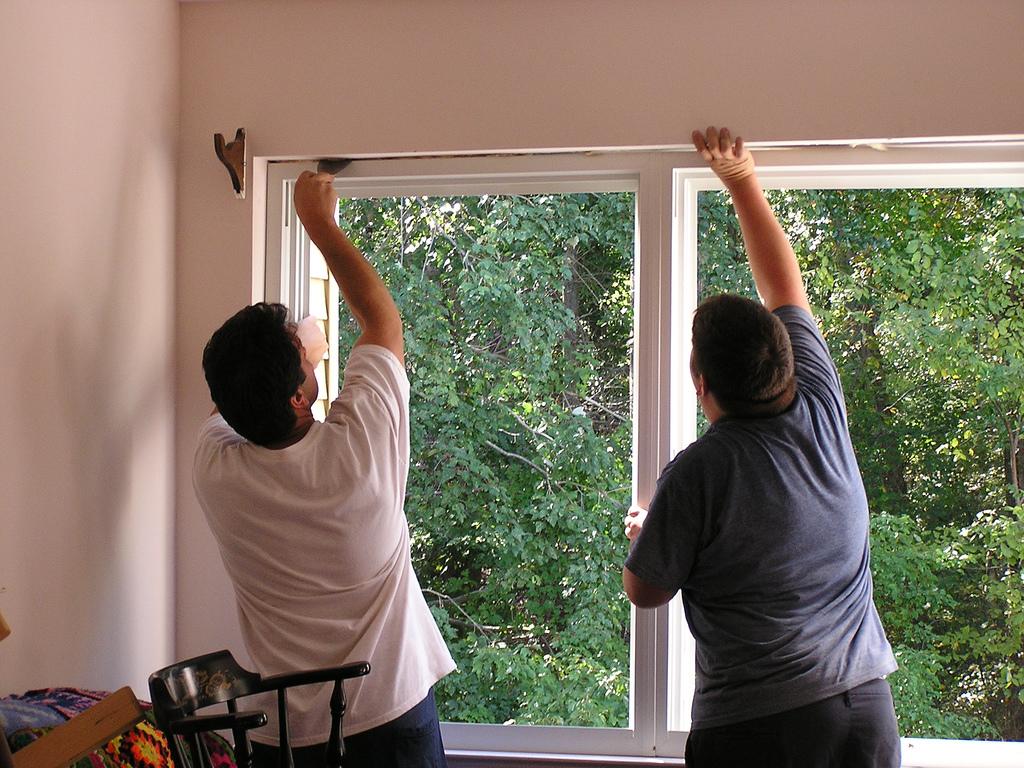 men installing window